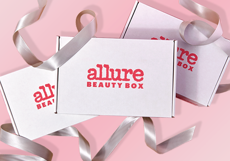 3 Allure Beauty Boxes with silver ribbon on a pink background.