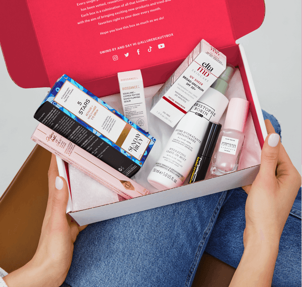 Box of beauty products on a woman's lap